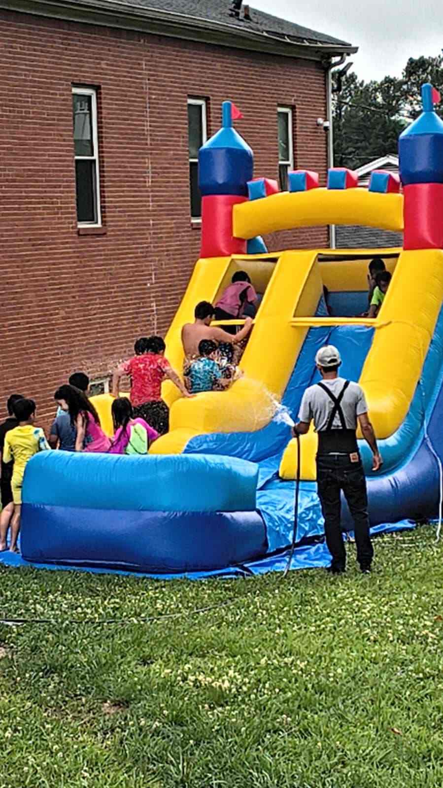 Children playing on a water slide