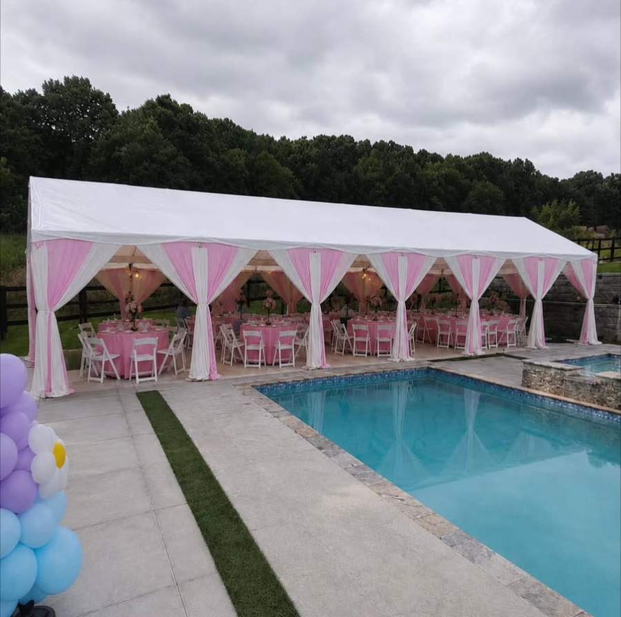 Long pink and white draped tent beside a pool