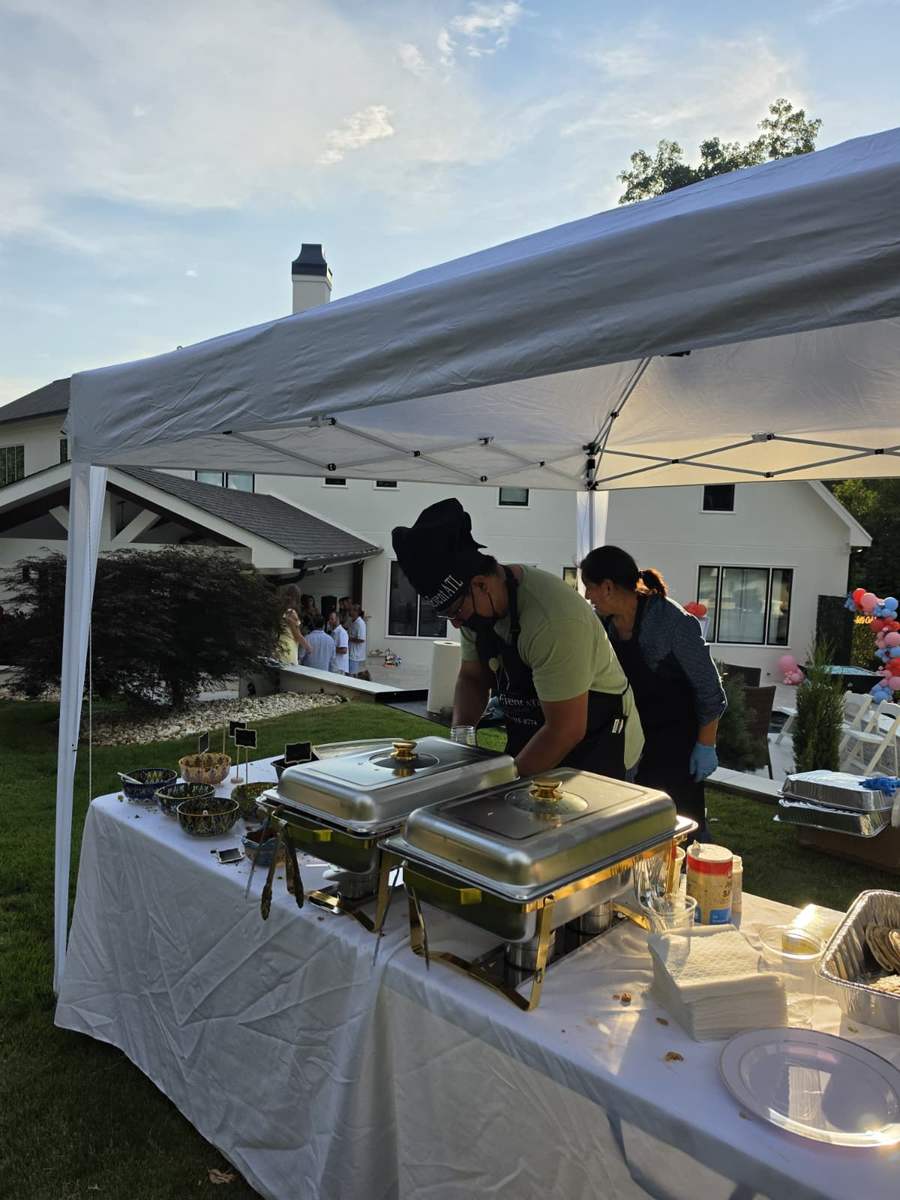 DecoEvent ATL team serving guests from the taquiza station at sunset